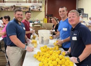 Blessings of Hope - Group of People Working in Kitchen With Lemons